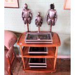 A collection of three reproduction miniature sets of model armour on wooden stands,