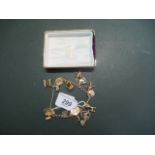 A 9ct yellow gold charm bracelet set with numerous charms.