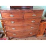A Georgian mahogany bow front chest, having two short over three long drawers on out-swept supports,