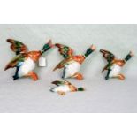 A set of four Beswick flying ducks, no. 596, numbers: 1, 2 3, & 4, the largest 25cm wide.