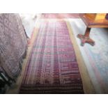 A Beluch-style large rectangular carpet, 360cm x 115cm.