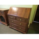 A reproduction five drawer bureau.