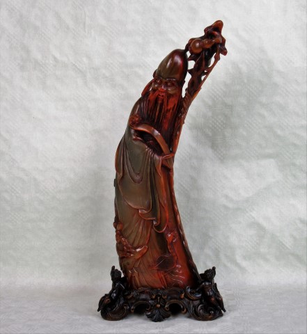 A large horn figure of Shoulao, 19th century, the figure leaning to one side,