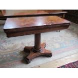 A Victorian mahogany swivel top fold-over card table over plain column, on quatrefoil base,