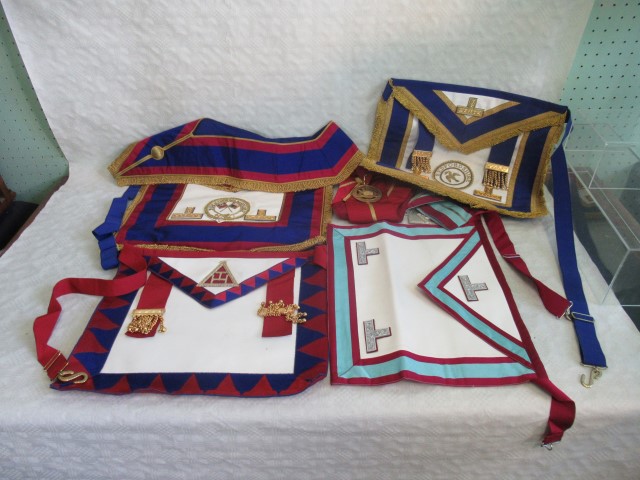 A collection of five assorted Masonic ceremonial aprons.
