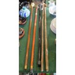 Five assorted walking sticks with handles of varying form.