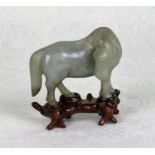 A Chinese pale celadon carved study of a horse, head turned to the right, 7cm long,