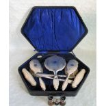 A cased six piece dressing table set, having engine turned silver backs,