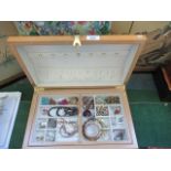 A contemporary jewellery box containing a quantity of costume jewellery, to include: bangles,