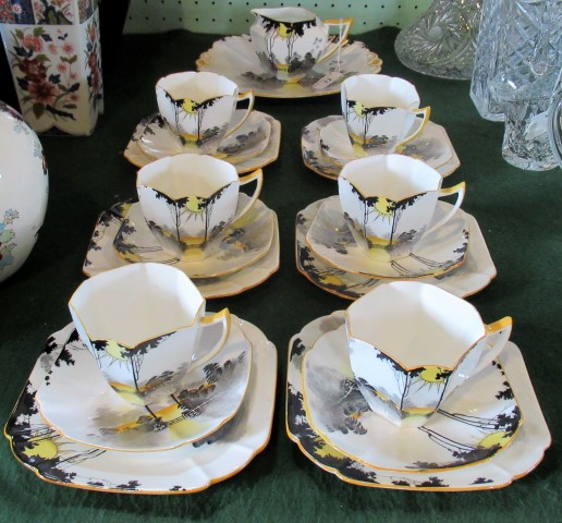 An early 20th century Shelley part-tea service, in the Sunset and Tall Trees pattern,