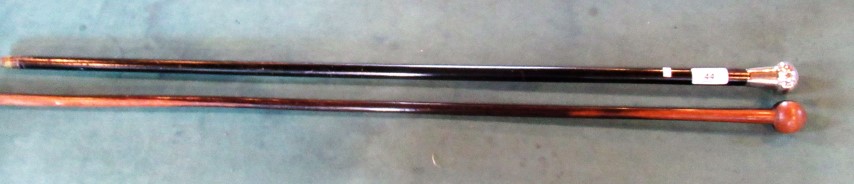 An ebonised walking cane with silver mount, 91.5cm, together with a further hardwood walking cane.