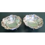 James Deakin & Sons, a pair of silver scalloped edge bowls, each on three feet,