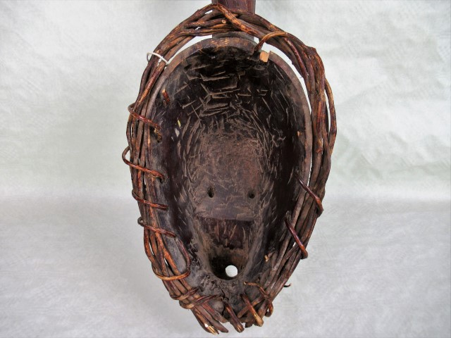 An African tribal mask, having white painted face, within a basket weave frame, 53cm. - Image 3 of 3