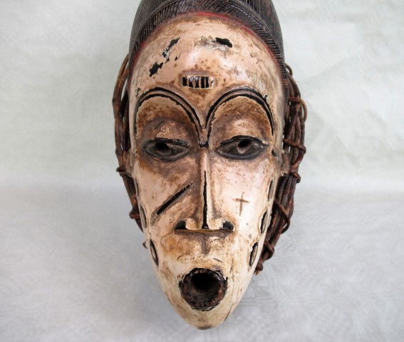 An African tribal mask, having white painted face, within a basket weave frame, 53cm. - Image 2 of 3