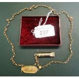 A 9ct gold box link chain, set with a whistle and Egyptian charm.