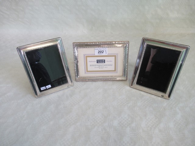 Three silver picture frames.