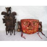 An African carved tribal wall mask, formed as two conjoined faces with bird finial, 37cm,