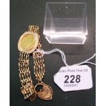 A Queen Elizabeth II half sovereign, dated 1982, to a 9ct gold gate link bracelet with heart locket.