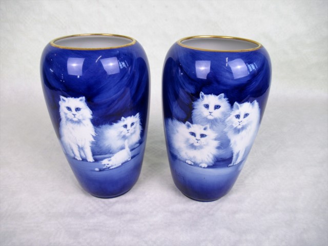 A pair of Grimwades Winton Ware vases, each depicting cats on a deep blue ground, signed B Austin,