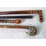 A collection of four walking sticks, early 20th century and later.