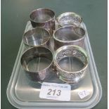 A collection of six silver and white metal napkin rings.