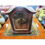 An oak cased bracket clock, the gilt dial bearing Roman numerals, eight day coil striking movement,