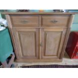 A pitch pine cupboard, having two drawers over two cupboard doors, 103cm wide.