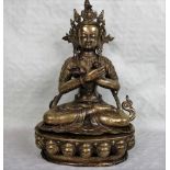 A Tibetan gilt-alloy figure of Vajradhara, seated in Dhyanasana on a conforming single lotus base,