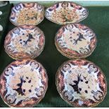 A quantity of Royal Crown Derby Imari Kings pattern plates and two serving dishes.