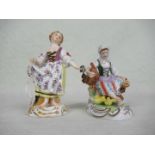 A Meissen porcelain figurine, a young girl holding a bunch of grapes,