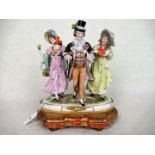 A Sitzendorf porcelain figure group, a gentleman with two ladies,