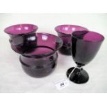 Three 19th century amethyst glass bowls of flared rim form, 13cm diameter,