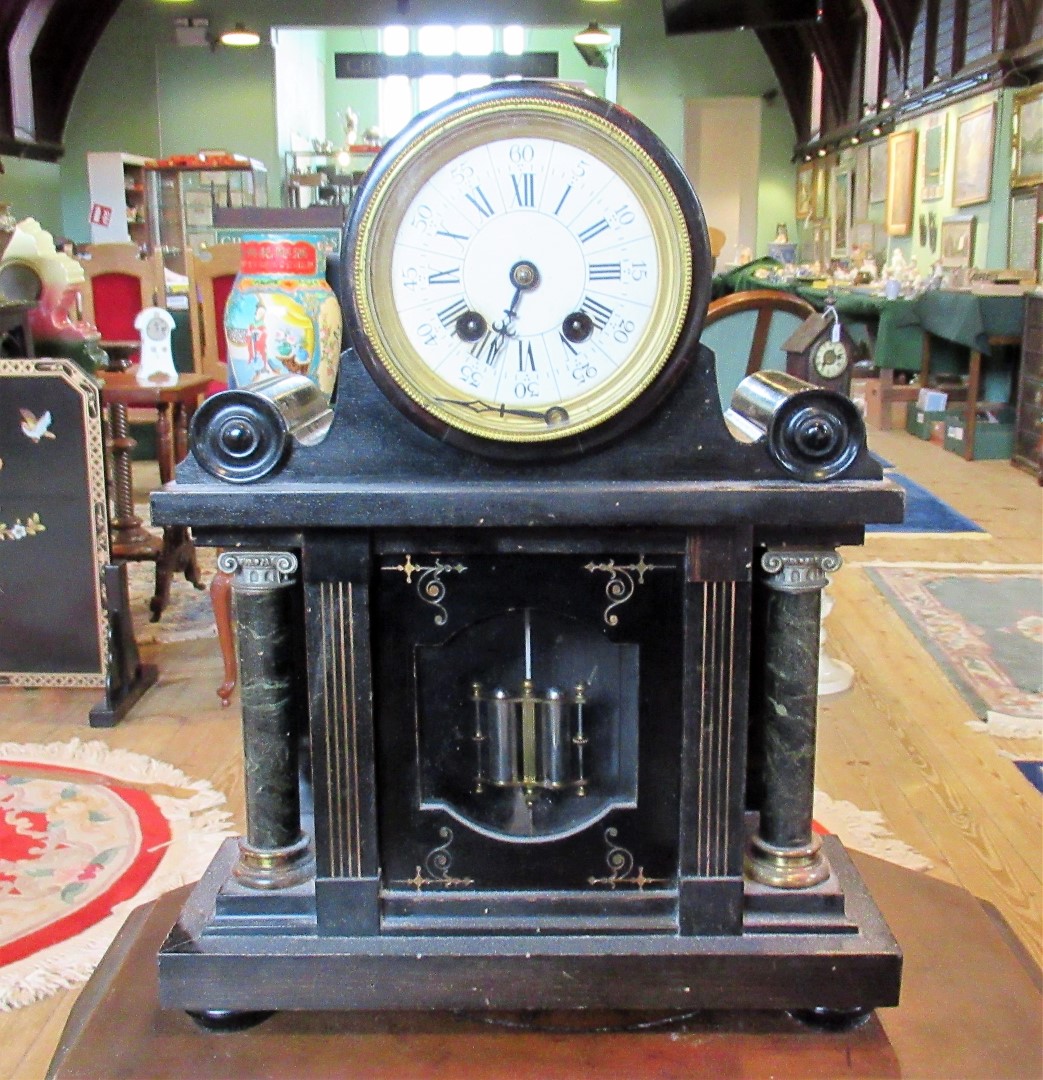 An Edwardian wooden simulated black slate and marble drum head mantle clock,