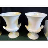 A pair of Wedgwood campagna shaped urns, each cream matt glazed, impressed and printed marks.