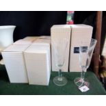 A set of six Caithness glass champagne flutes, each etched with wheat (four boxed),