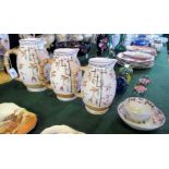 A graduated set of three late 19th century earthenware jugs,