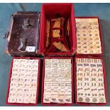 A late 19th/early 20th century leather cased travelling Mahjong set with bone tiles,