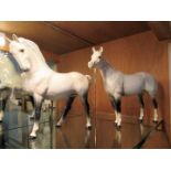 A Beswick dapple grey horse, with tail moulded to leg, together with another, trotting,