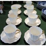 A Wedgwood Etruria set of seven coffee cans & saucers, each white glazed with gilt loop handle,