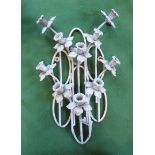 A silver painted wrought iron wall mounting garden decoration, fashioned as miniature daffodils.
