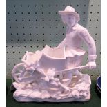 A Blanc de Chine figure of a young man pushing a barrow, unmarked.