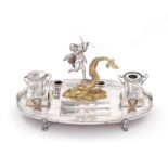 Continental silver figural ink stand 19th century, cupid riding aloft gilt dolphin forming lid