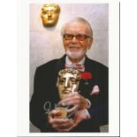 Sir John Mills signed 7 x 5 colour photo holding a BAFTA award. Good condition. All signed items