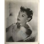 Judy Garland signed 10x8 sepia vintage photo. Couple of knocks and tape marks to border of photo but