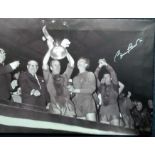 Bobby Charlton signed 24 x 18 inch canvas print holding the Football European Cup. Mounted on wood