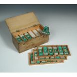 A collection of seventy two microscope slides, botanical and animal tissues, housed in a fitted