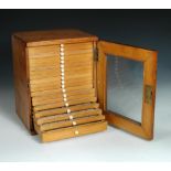 A collection of approximately two hundred and fifty microscope slides, housed in a pine box,