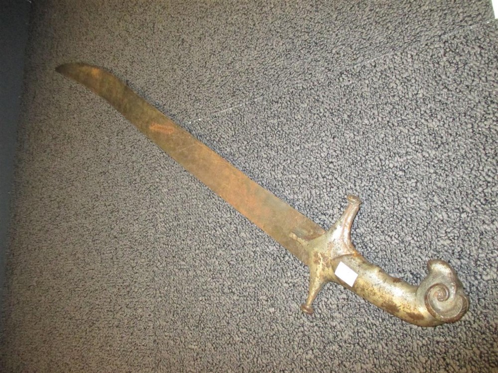 An Indian Tulwar, with heavy curved blade and silvered rams head pommel, together with an Eastern