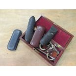 A mahogany box containing a collection of ophthalmic measuring instruments, together with four pairs
