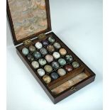 A 19th century rosewood box containing a collection of rocks and minerals, together with a